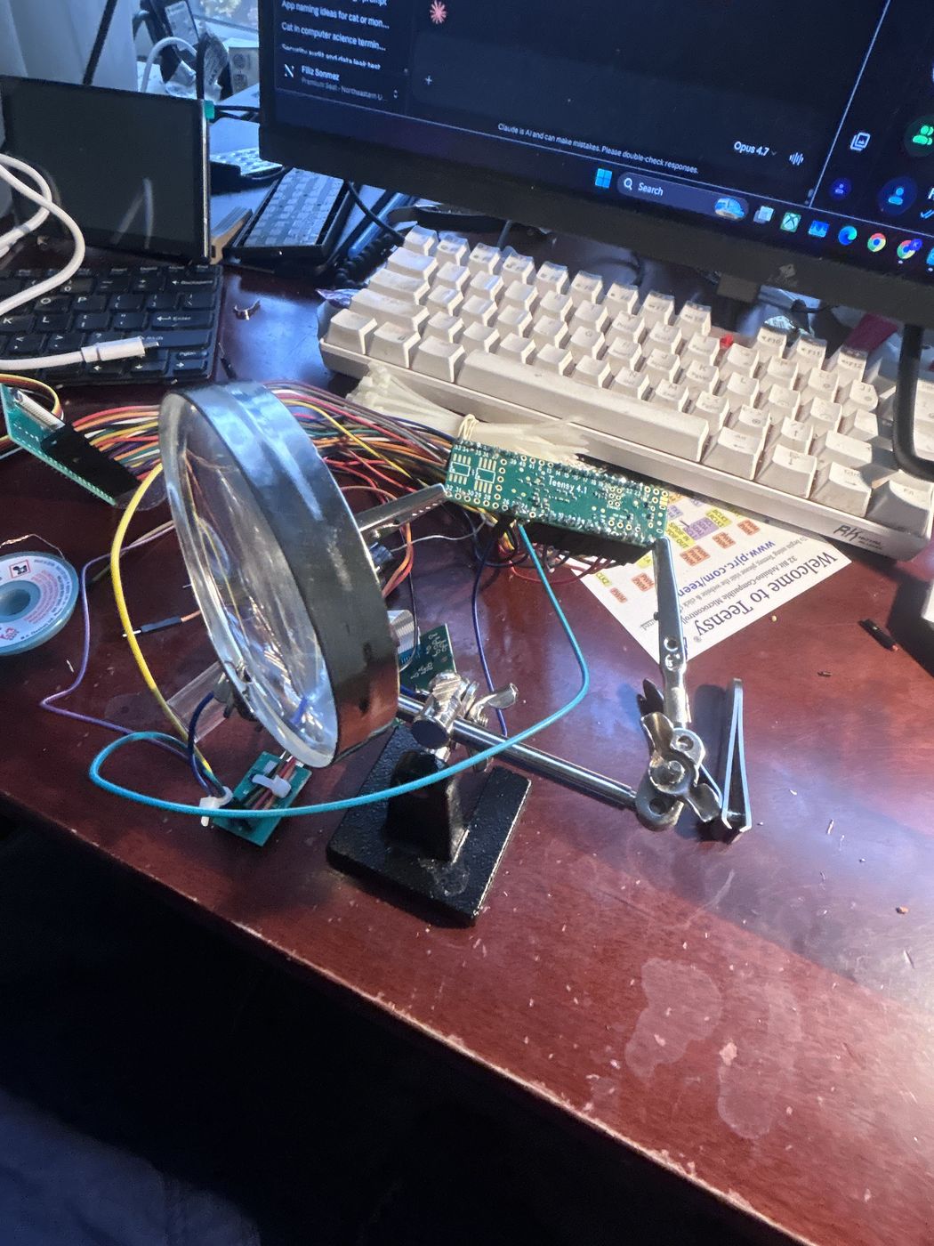 Soldering station with helping hands and a magnifier holding the Teensy